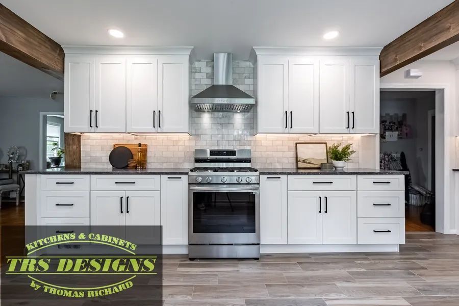 A kitchen with white cabinets and a stainless steel dishwasher.