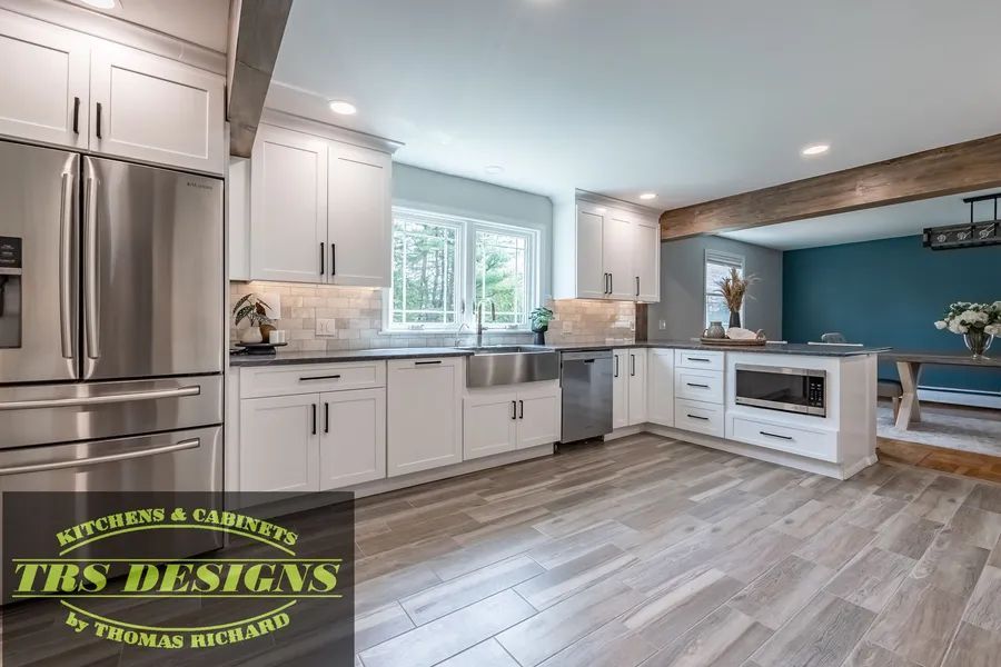 A kitchen with white cabinets and modern appliances.