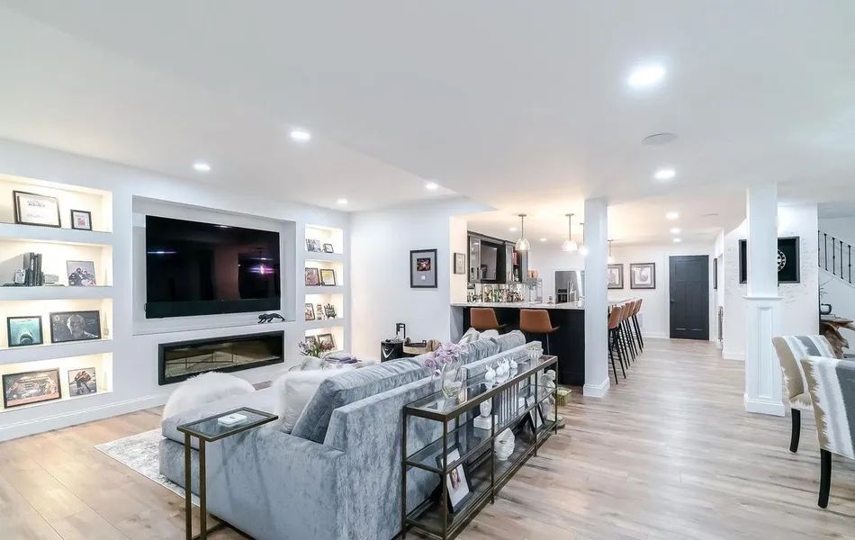A living room with a large couch and a flat screen tv.