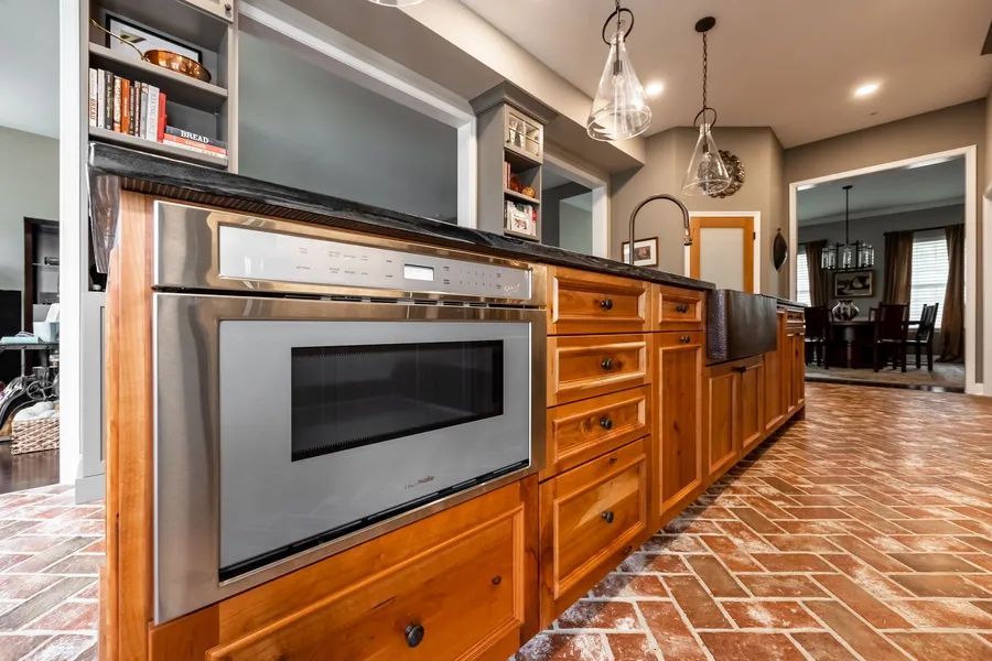 A kitchen with wooden cabinets and stainless steel appliances.