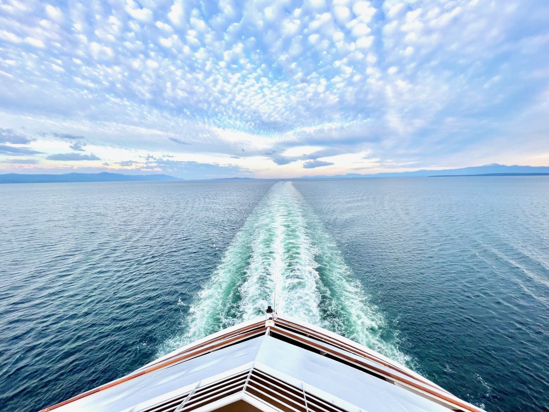 A cruise ship is floating on top of a large body of water.