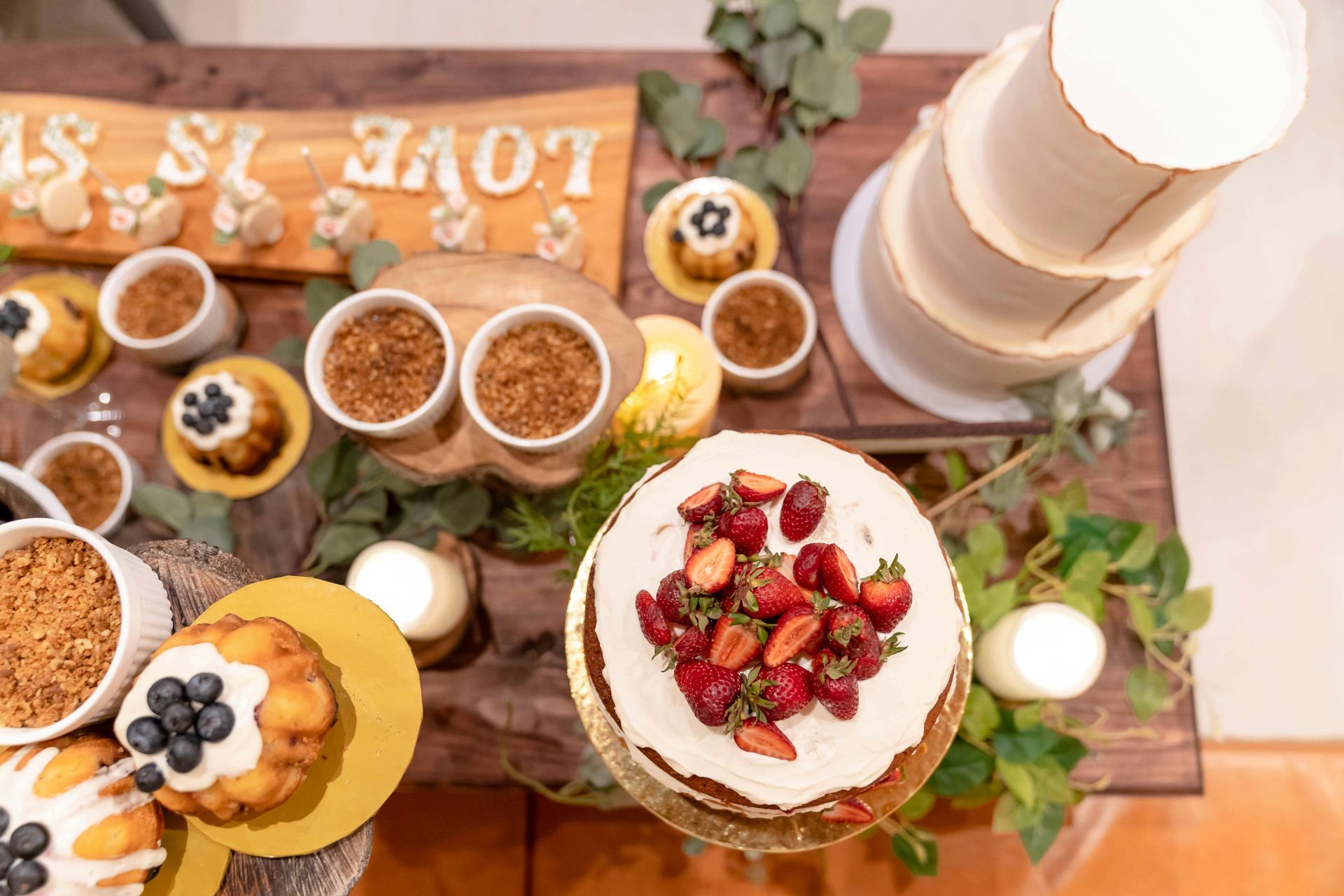 A table topped with a variety of desserts and cakes.
