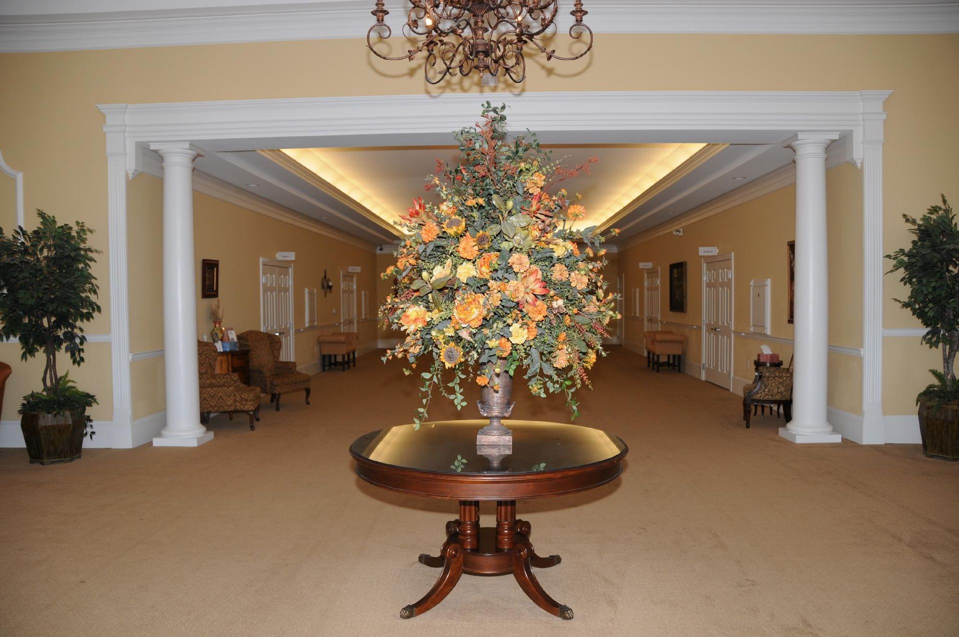 A table with a vase of flowers on it in a hallway