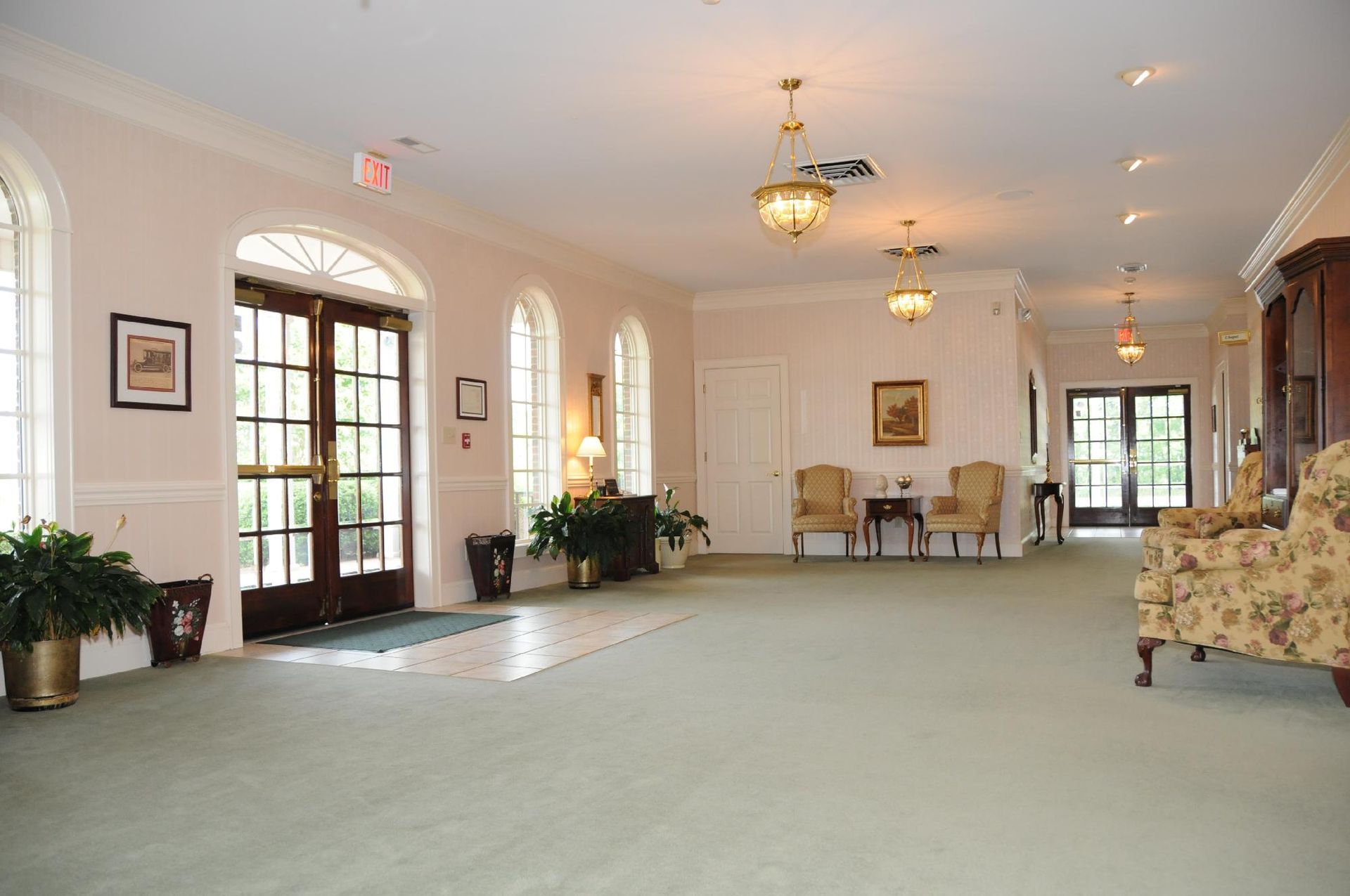 A large room with a lot of windows and chairs