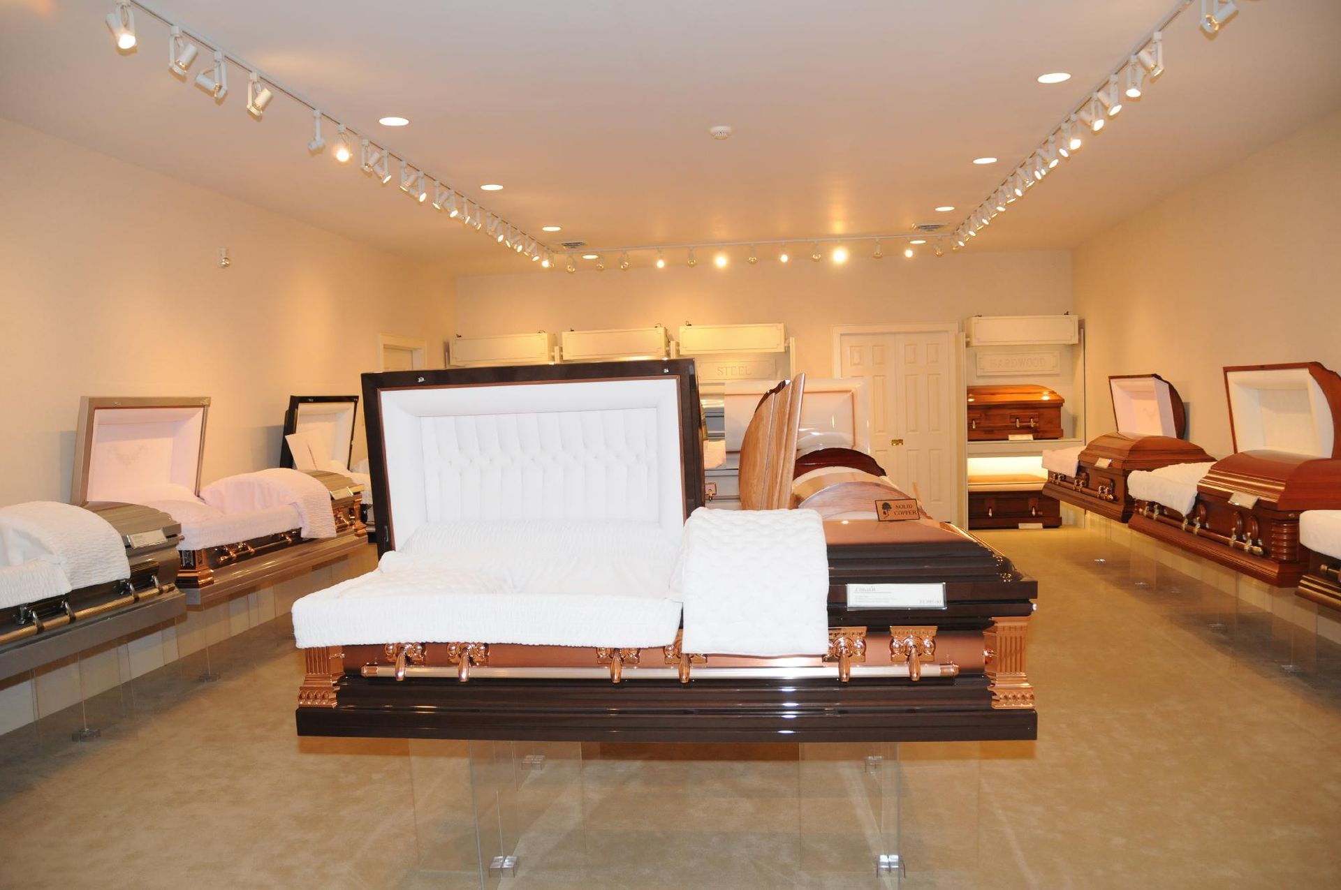 A row of coffins are lined up in a room.
