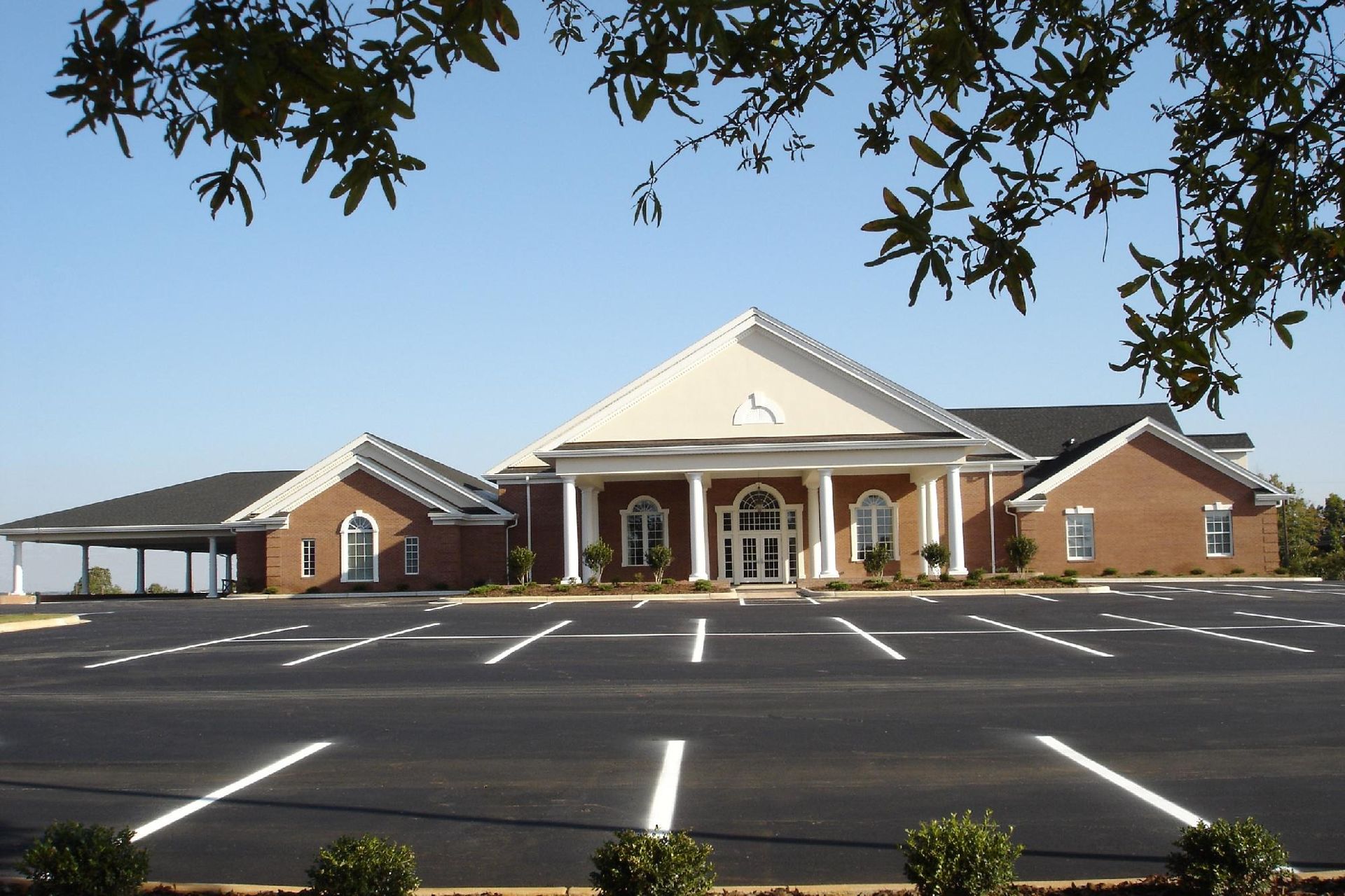 A large building with a lot of parking in front of it