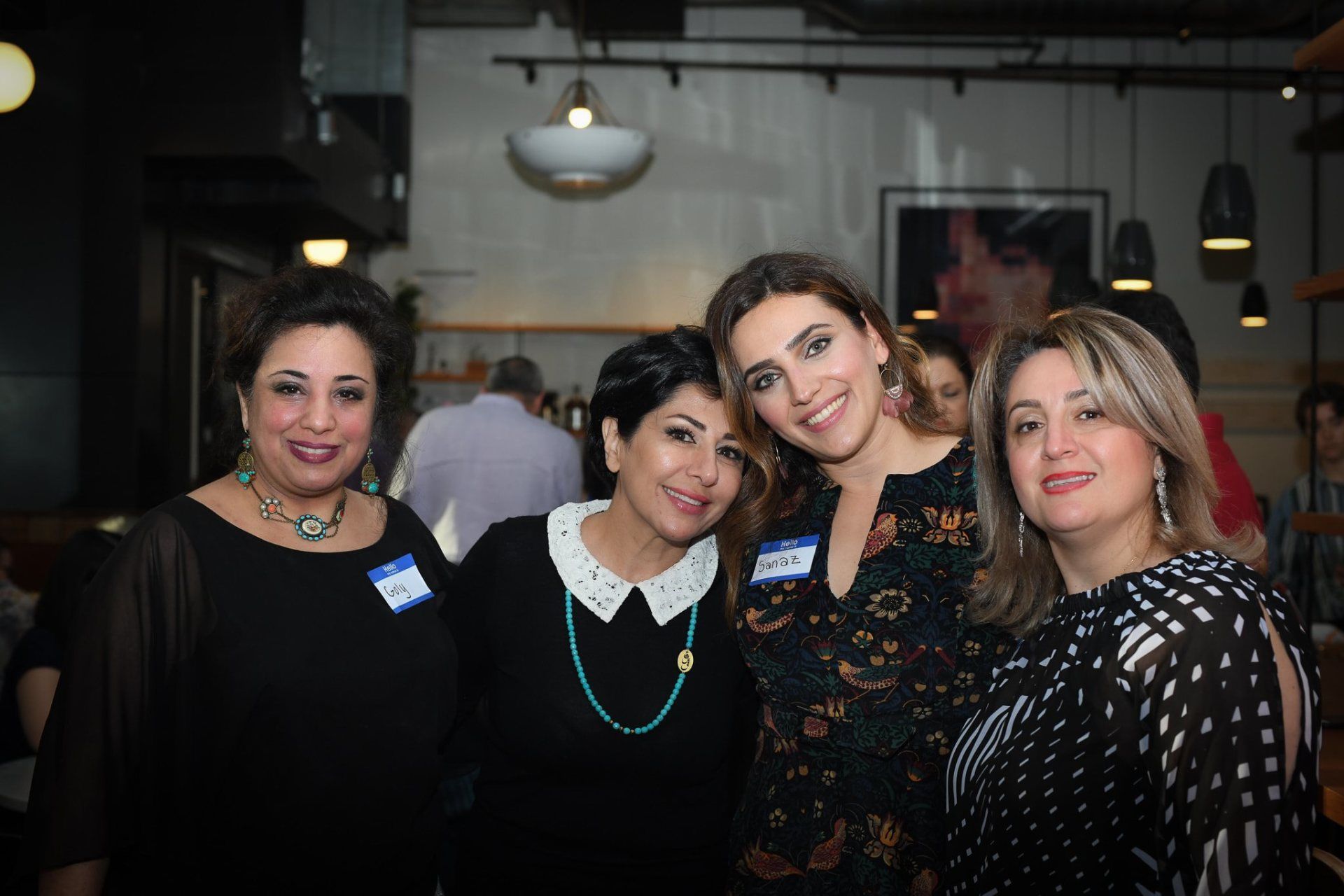 A group of women are posing for a picture together in a restaurant.
