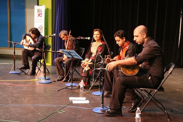 A group of people playing musical instruments on a stage