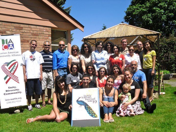 A group of people posing for a picture in front of a sign that says na