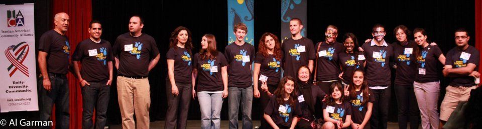A group of people are posing for a picture on a stage.