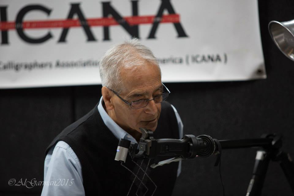 A man speaking into a microphone in front of a sign that says icana