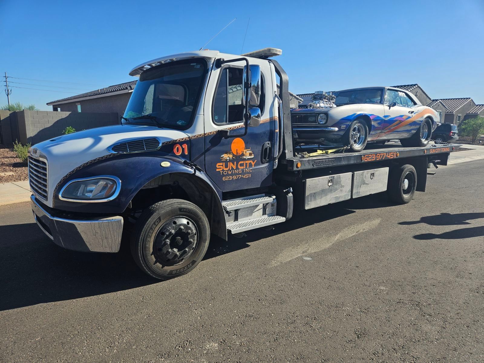 sun city tow truck towing a old sports car