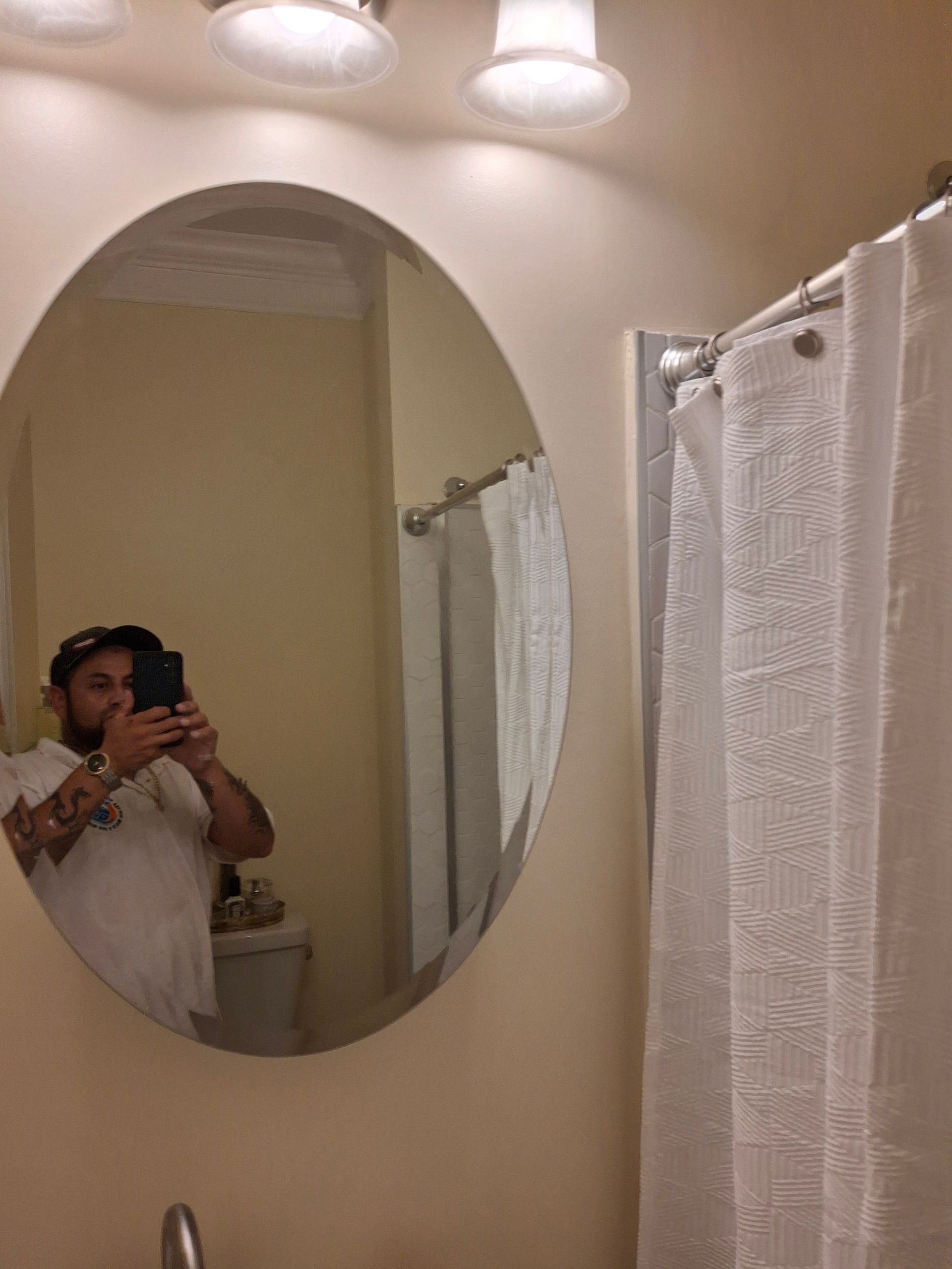 A man is taking a picture of himself in a bathroom mirror.