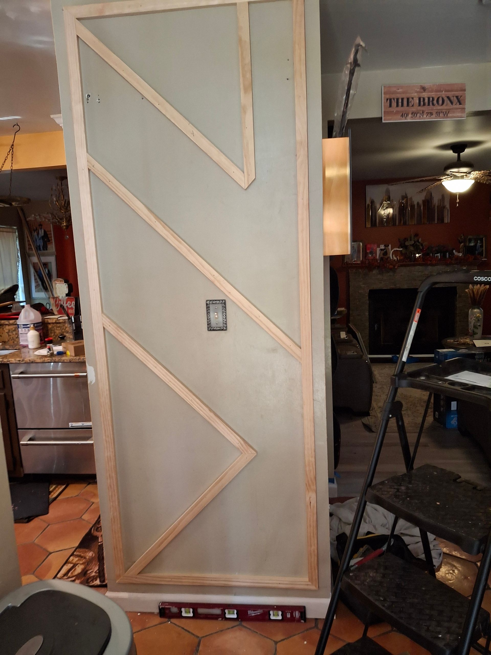 A wooden door is being built in a living room