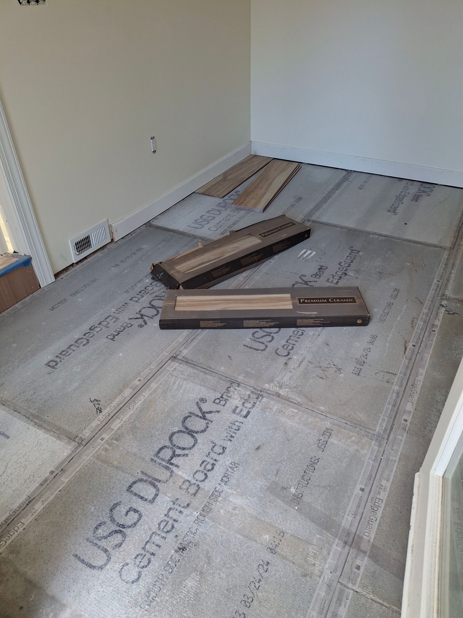 A wooden floor is being installed in a room.