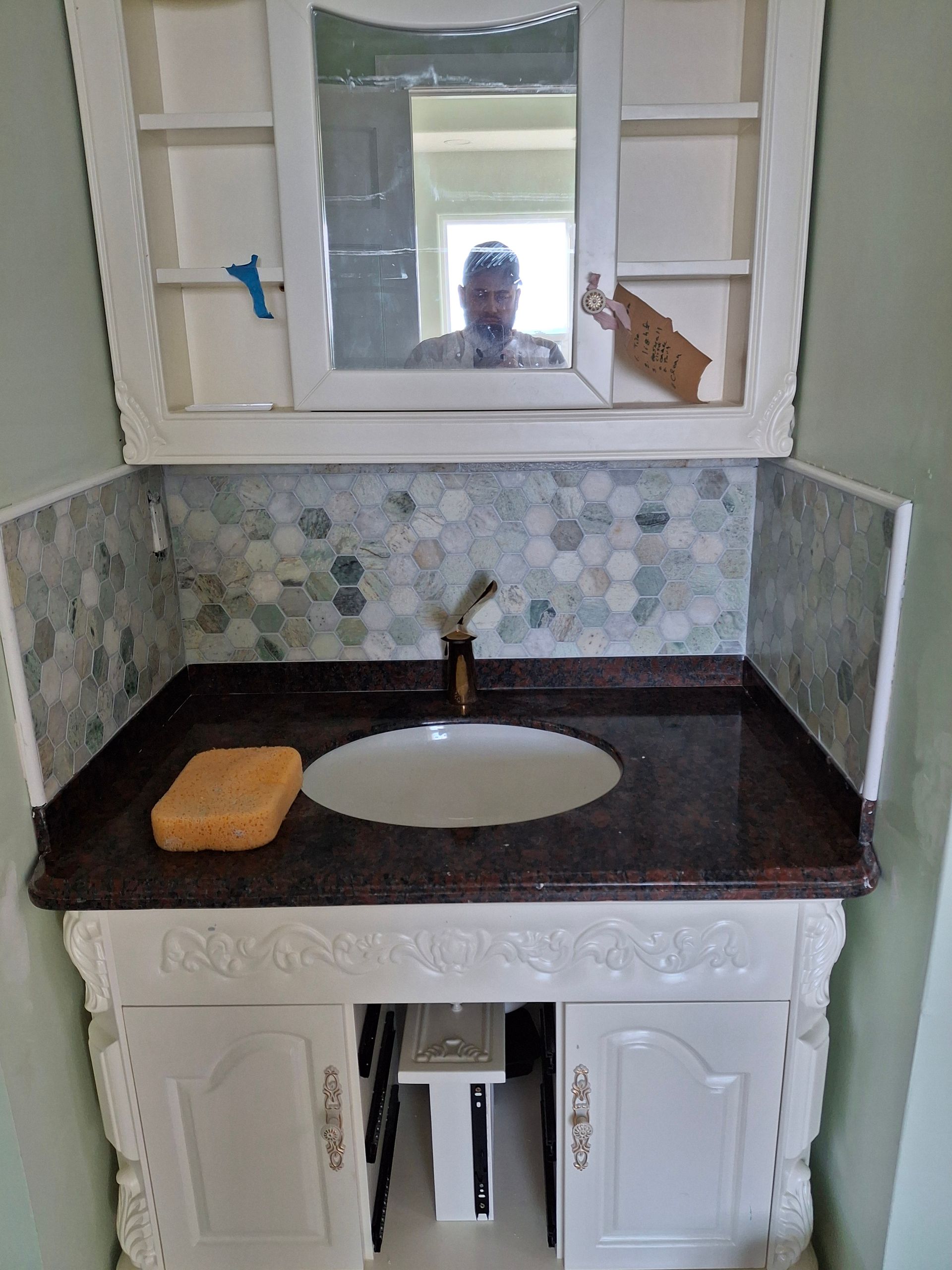 A bathroom vanity with a sink and a mirror