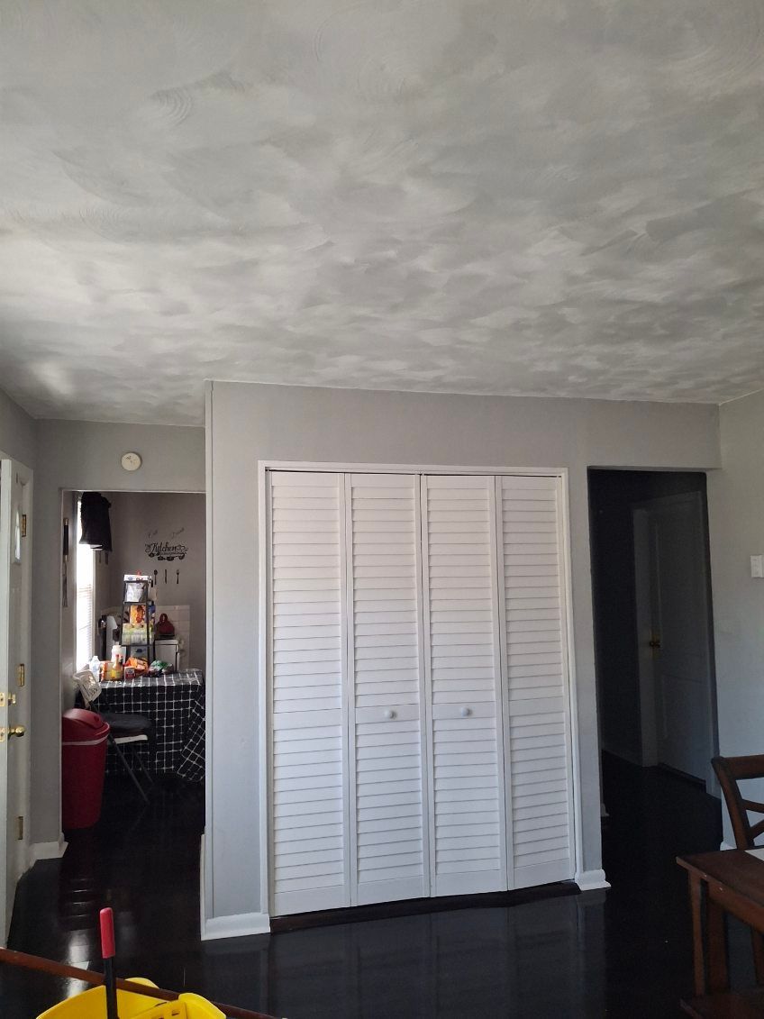 A room with a closet and a mop in it