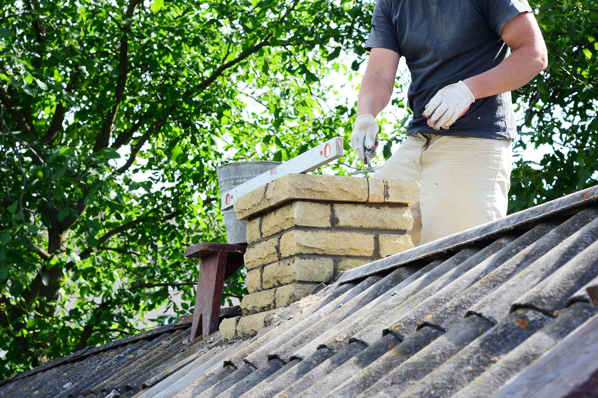 A man is working on a chimney.