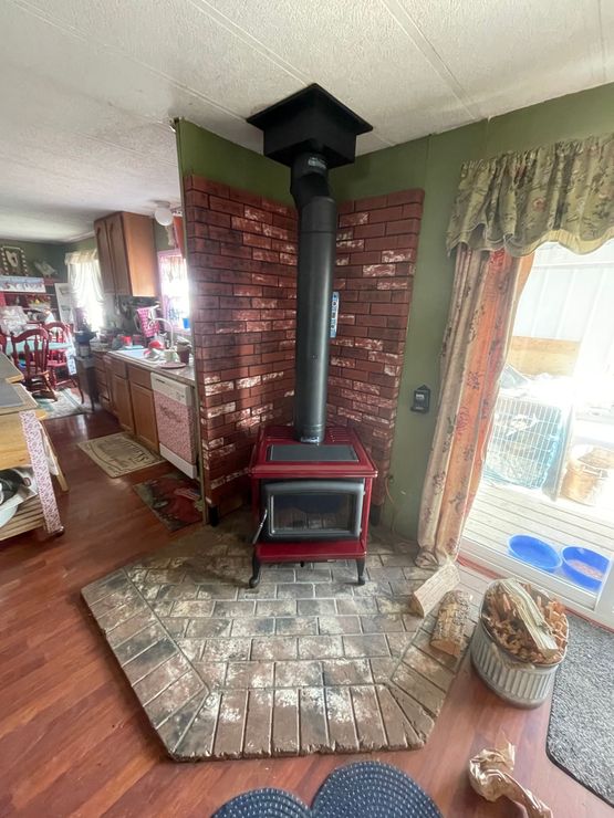 A fireplace with a picture of an elk on the mantle.