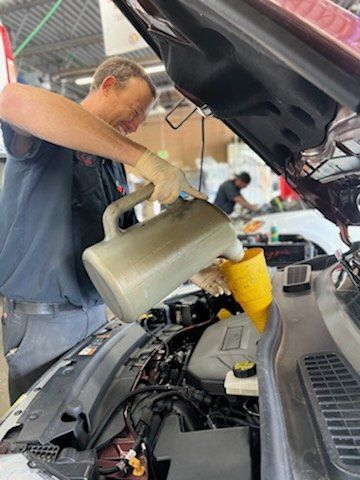 A mechanic changing fluid of a vehicle