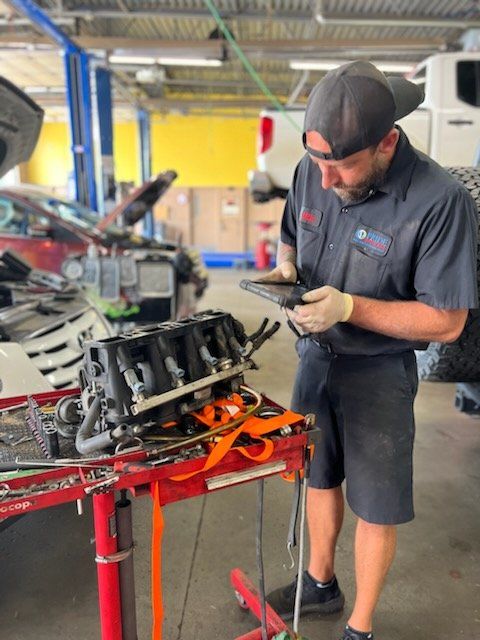 A mechanic working on a vehicle engine