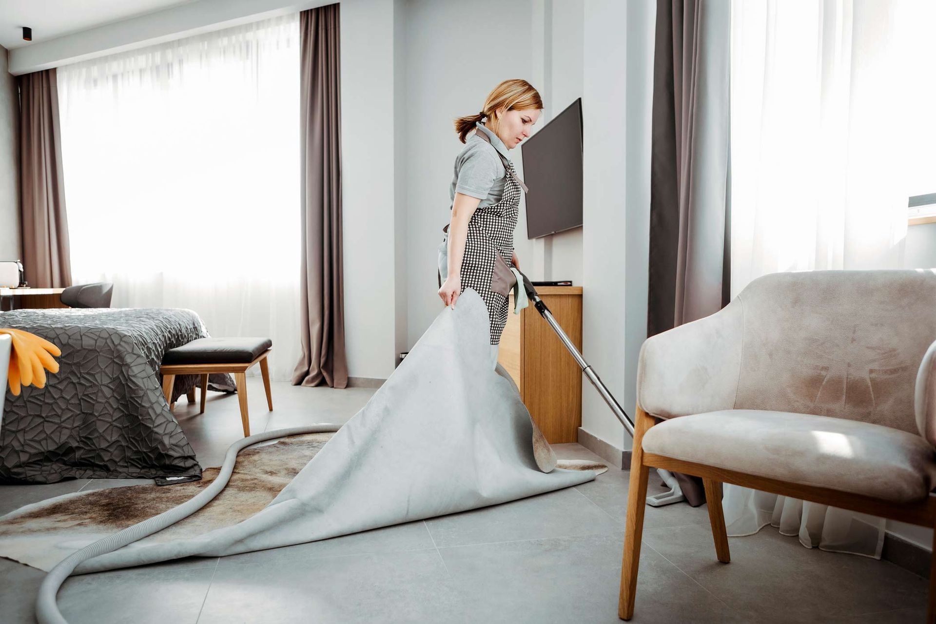 Maid Vacuuming Hotel Room — Appleton, WI — Confident Cleaners LLC