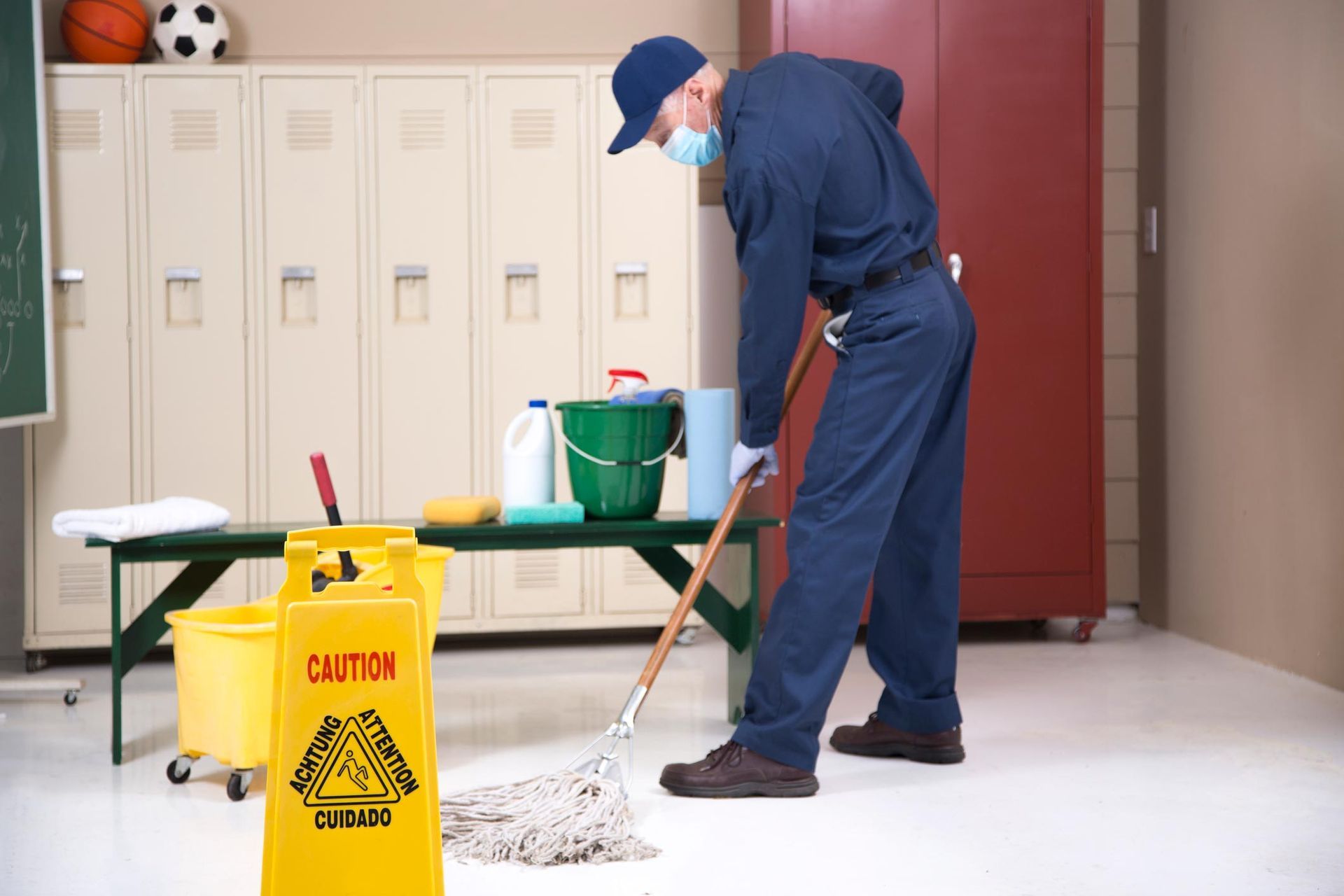 Senior Adult Janitor Mops Floor In School Locker Room — Appleton, WI — Confident Cleaners LLC