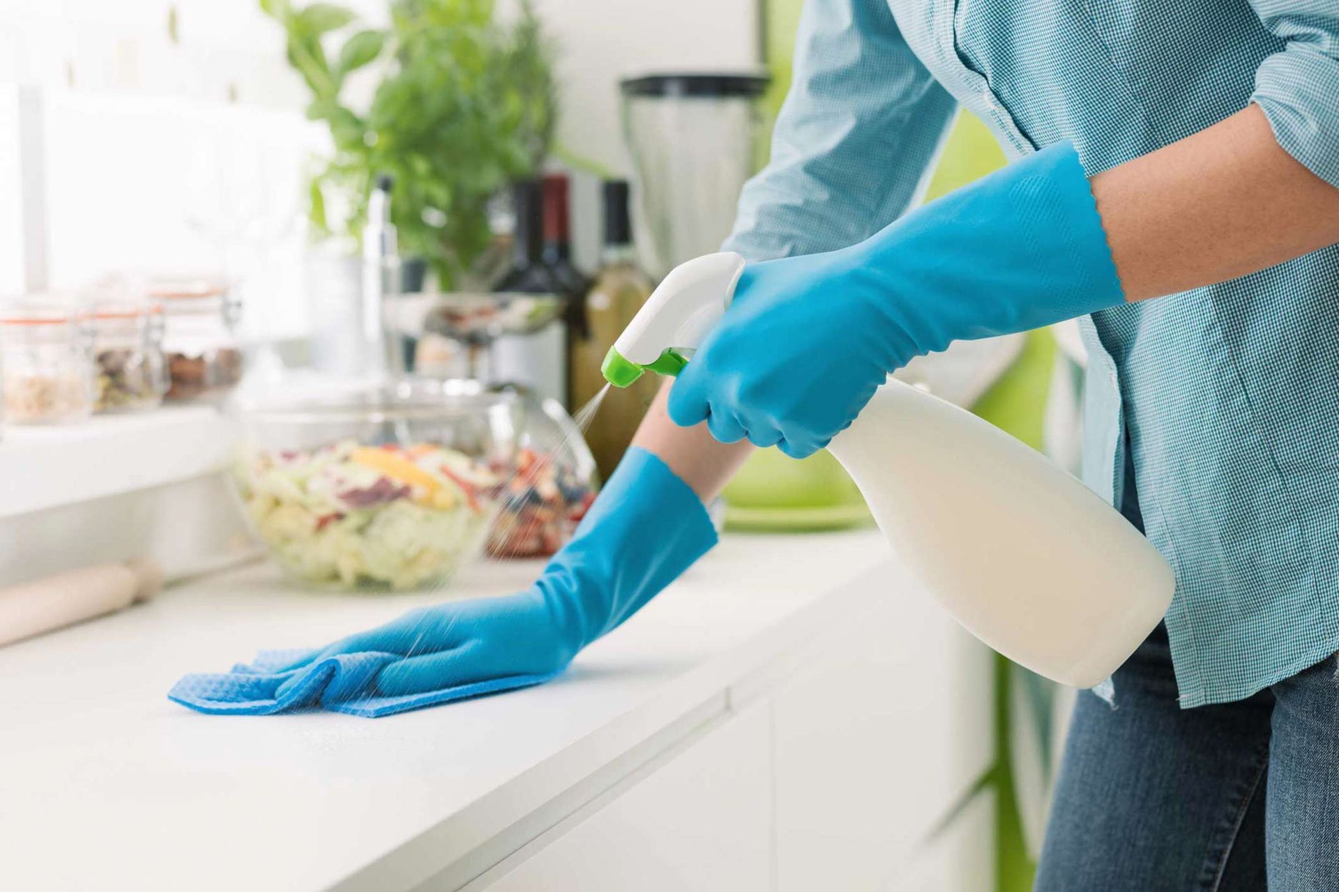 Woman Cleaning With A Spray Detergent — Appleton, WI — Confident Cleaners LLC