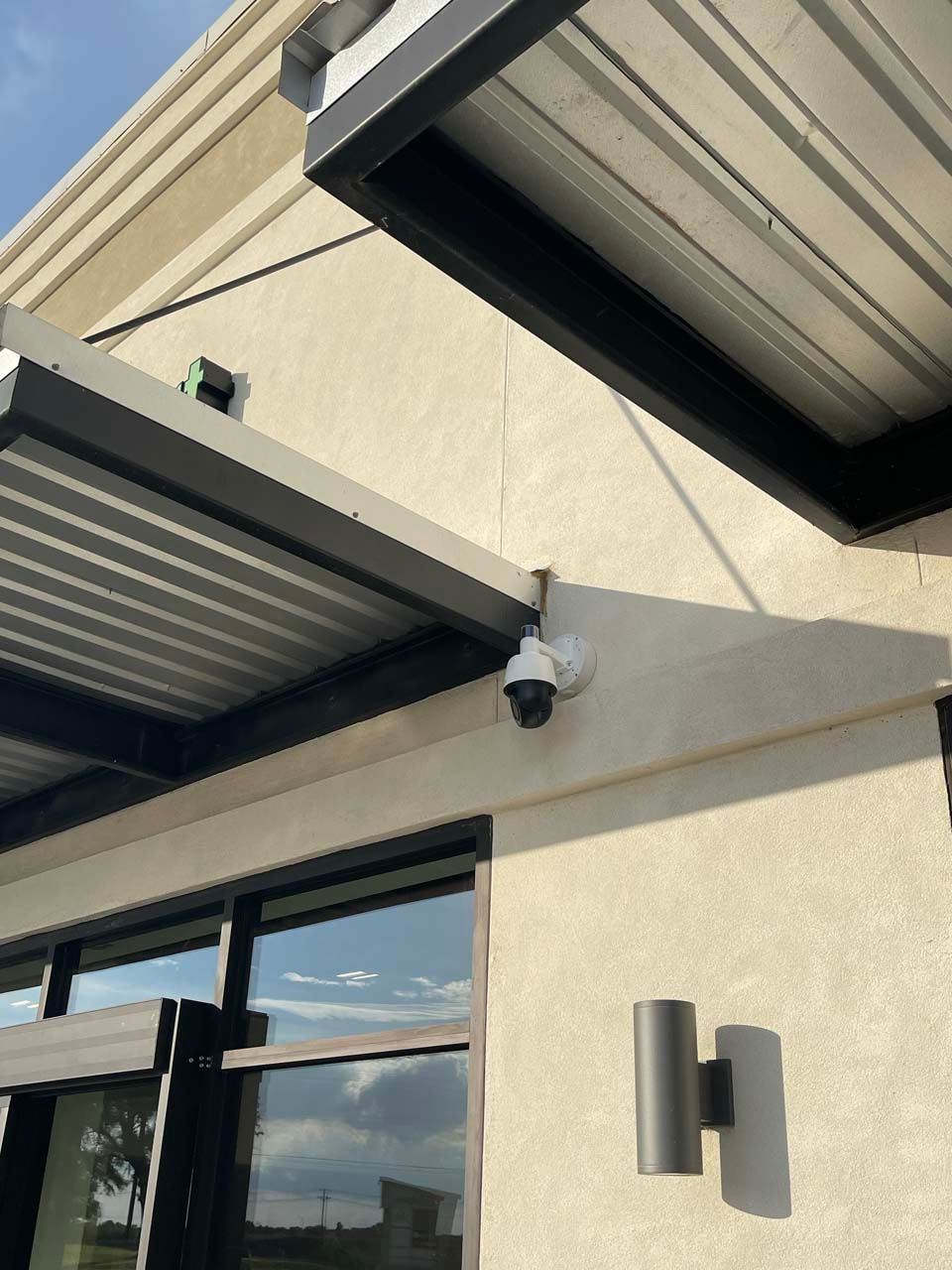 A security camera is mounted on the side of a building