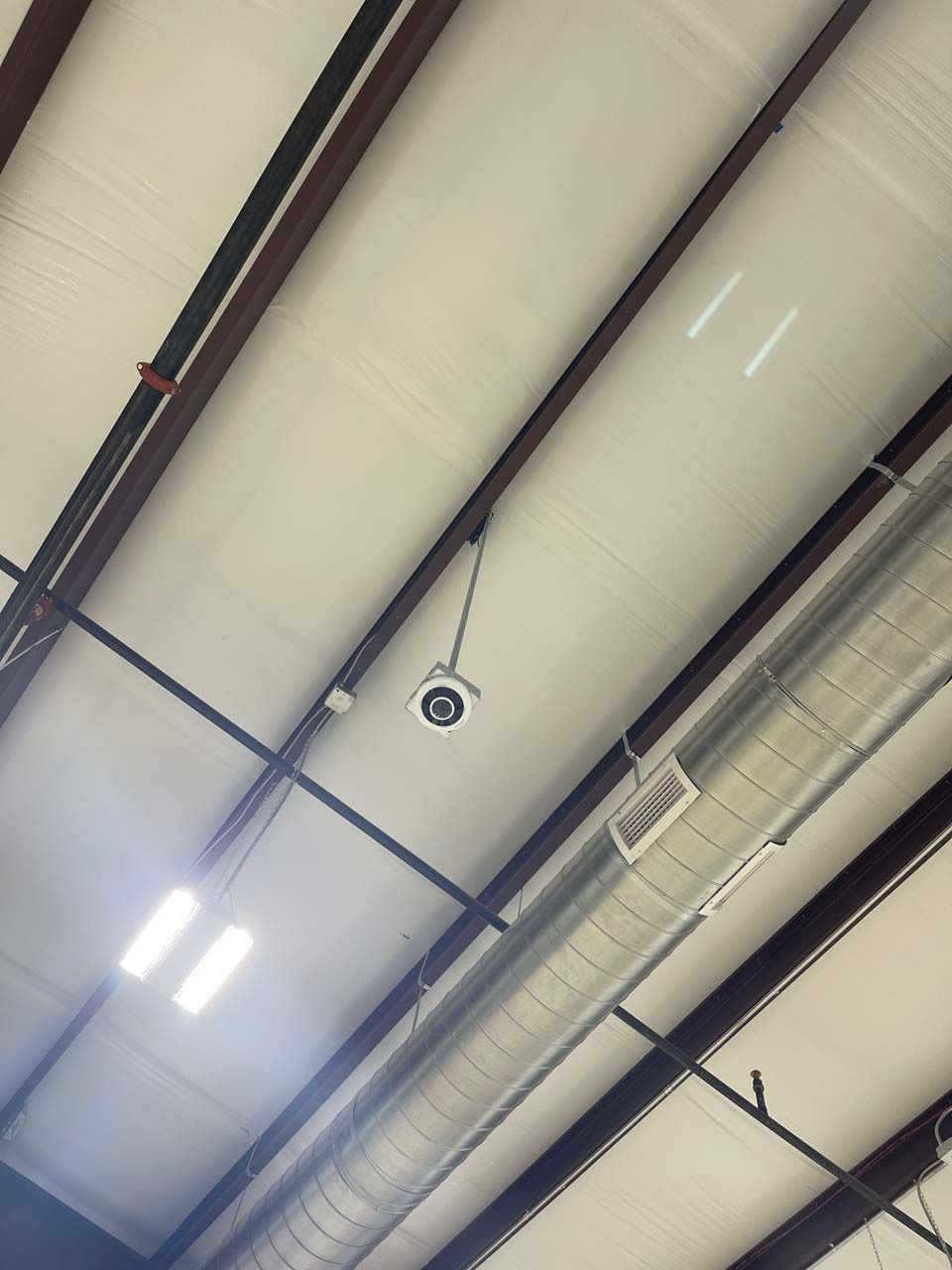 A ceiling with a lot of pipes hanging from it