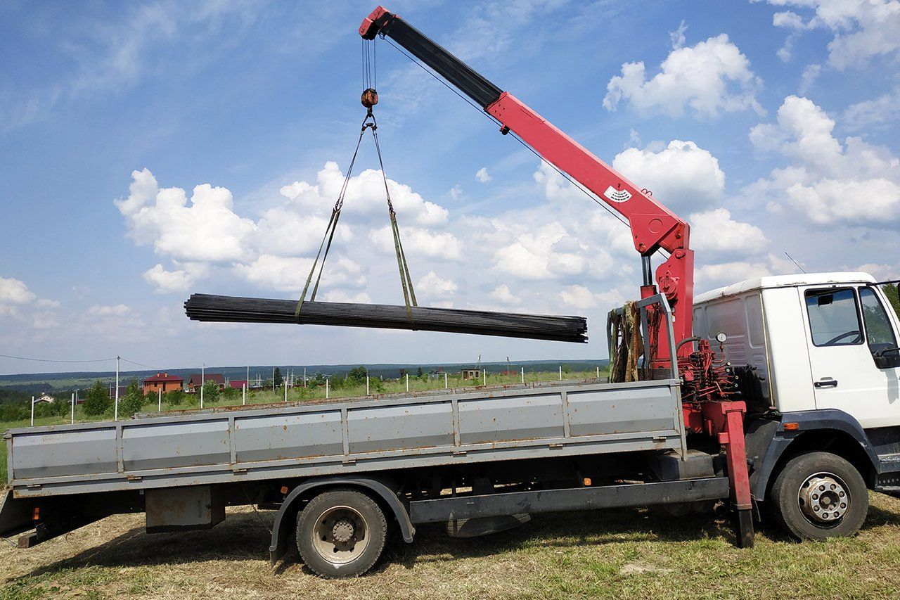 Loading Steel Rods On Crane Truck — Stockton, CA — Diamond Truck Body Manufacturing Inc.