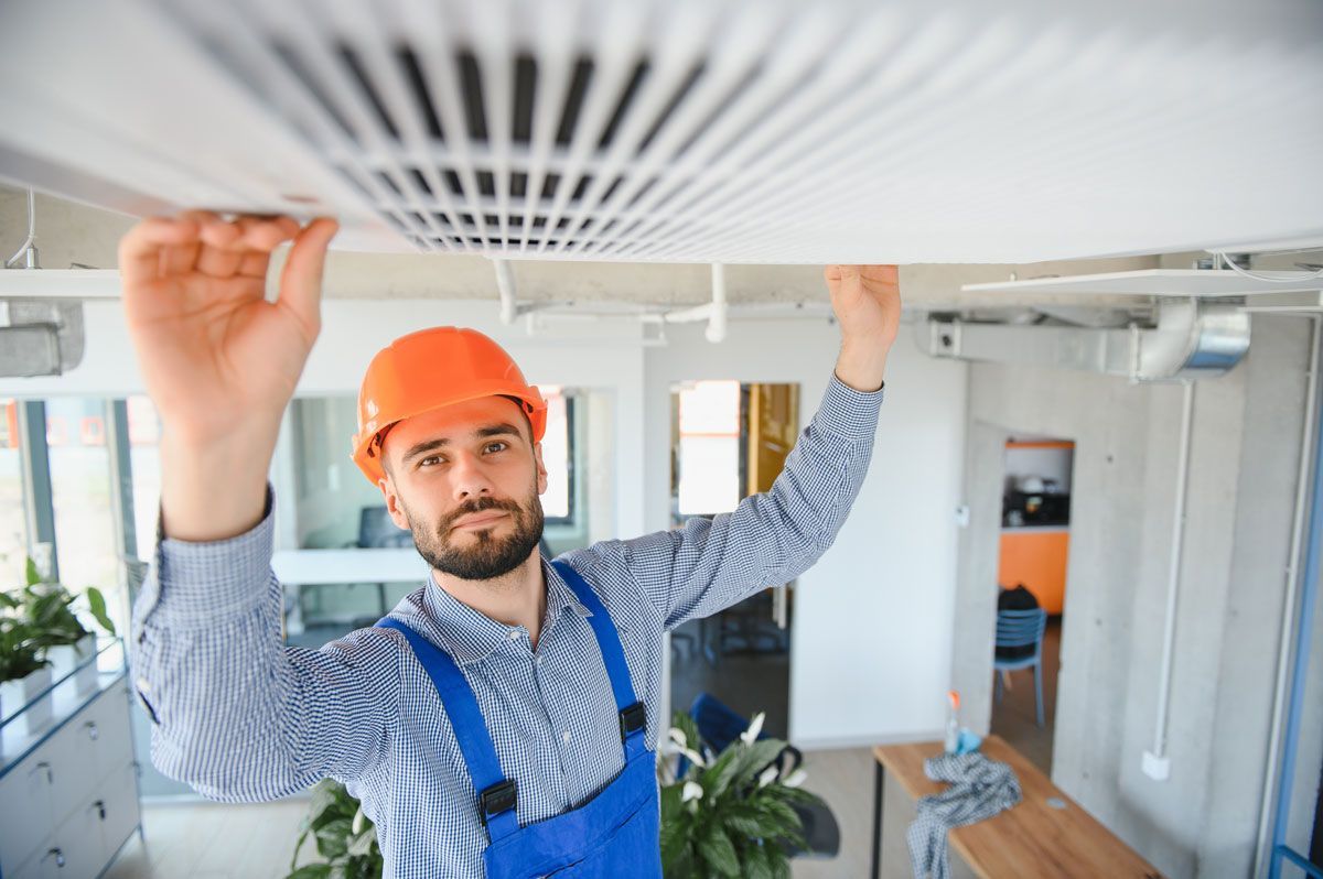 Male technician installing air conditioner for cool room
