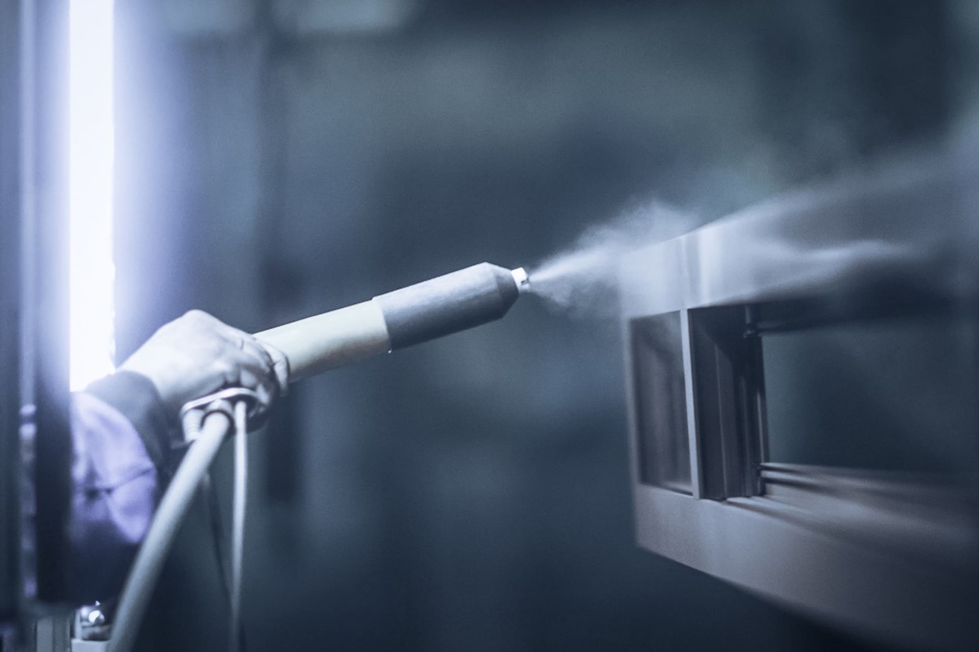 A Person Is Spraying Powder Paint on A Piece of Metal — A Brush With Colour in Urraween, QLD