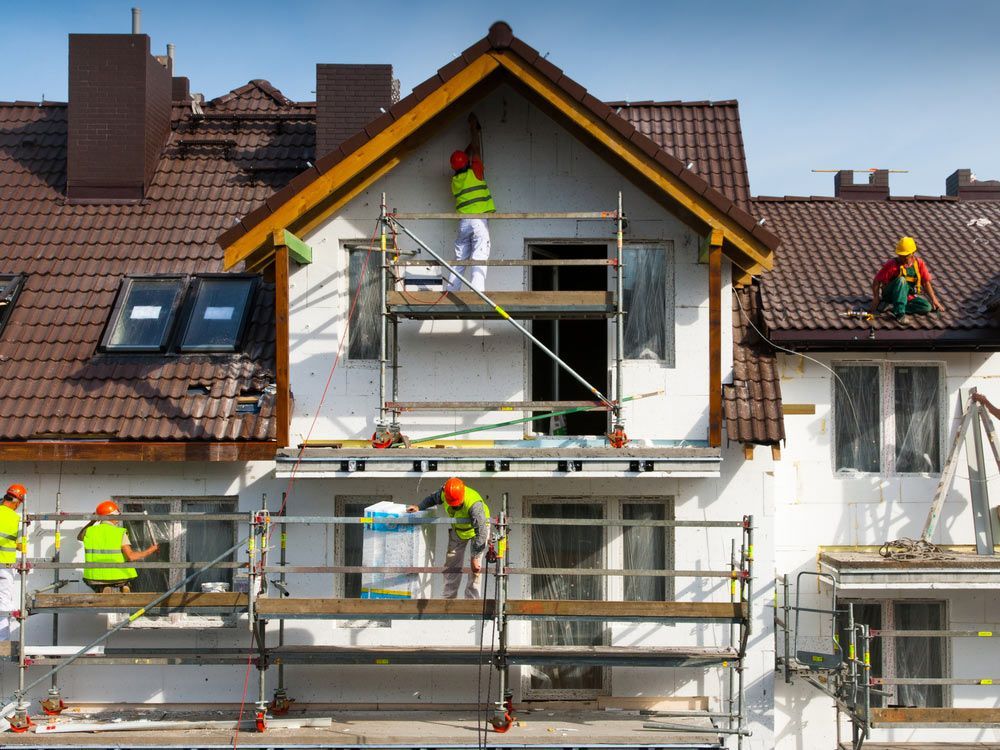 A Group of Construction Workers Are Working on A House Under Construction — A Brush With Colour in Craignish, QLD