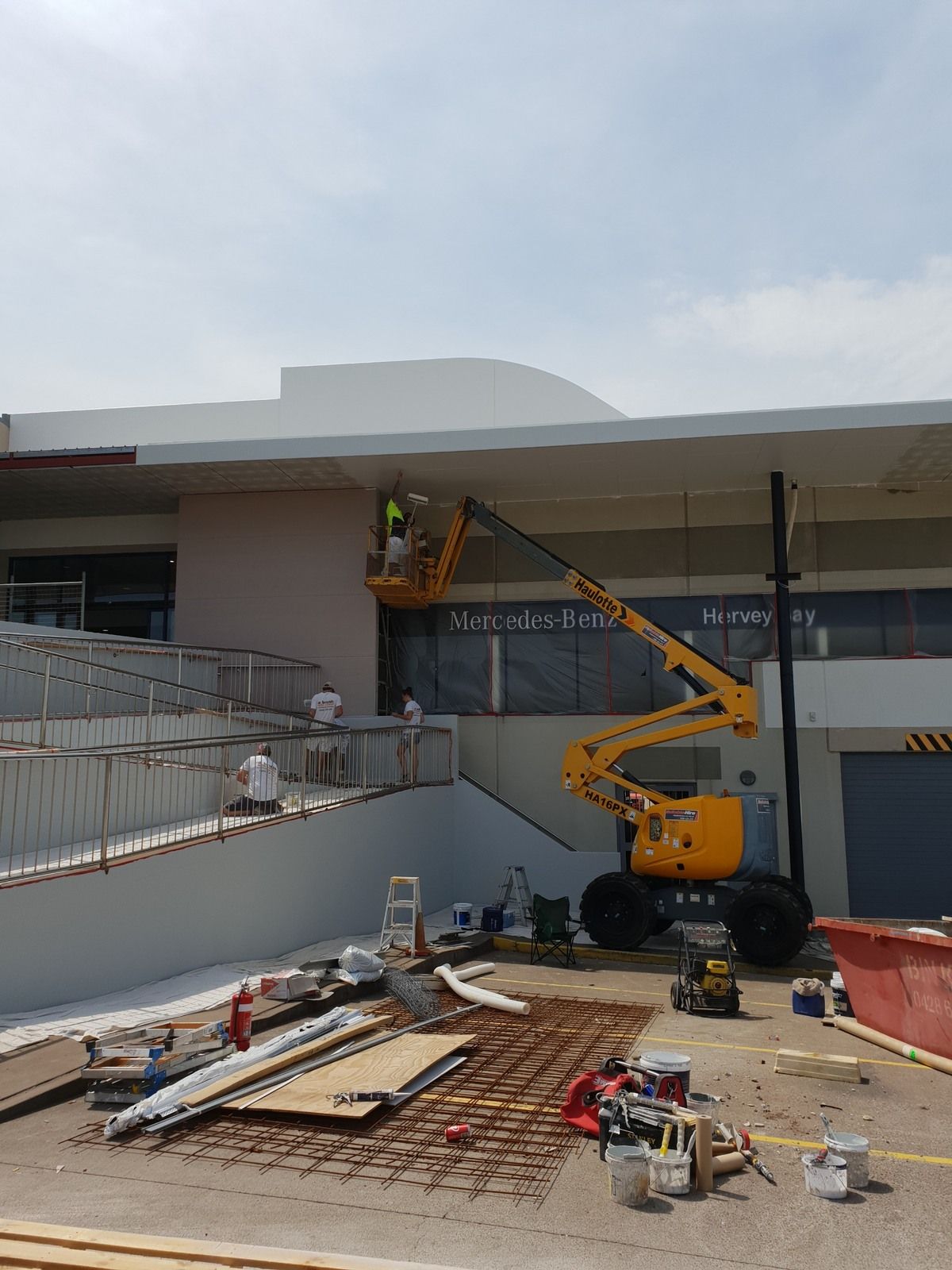 A Man Is Spray Painting the Ceiling of A Building — A Brush With Colour in Torquay, QLD
