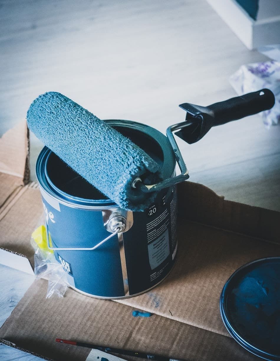 A Can of Blue Paint with A Roller in It — A Brush With Colour in Wondunna, QLD