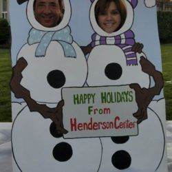 Two snowmen holding a sign that says happy holidays from henderson center