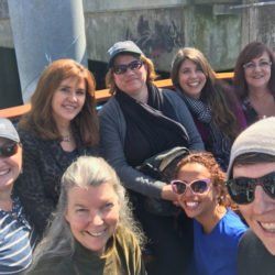 A group of people are posing for a picture together and smiling.