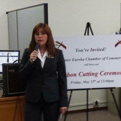 A woman is standing in front of a sign that says you 're invited.