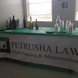 A petrusha law estate planning and administration table with bottles and cups on it.