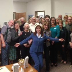A group of people are posing for a picture in a room.