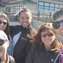A group of people wearing sunglasses are posing for a picture