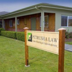 A sign for petrusha law is in front of a building.