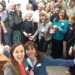 A group of people are posing for a picture in a room.