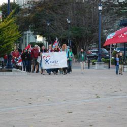 A group of people holding a sign that says casa