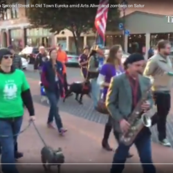 A man playing a saxophone in a crowd of people