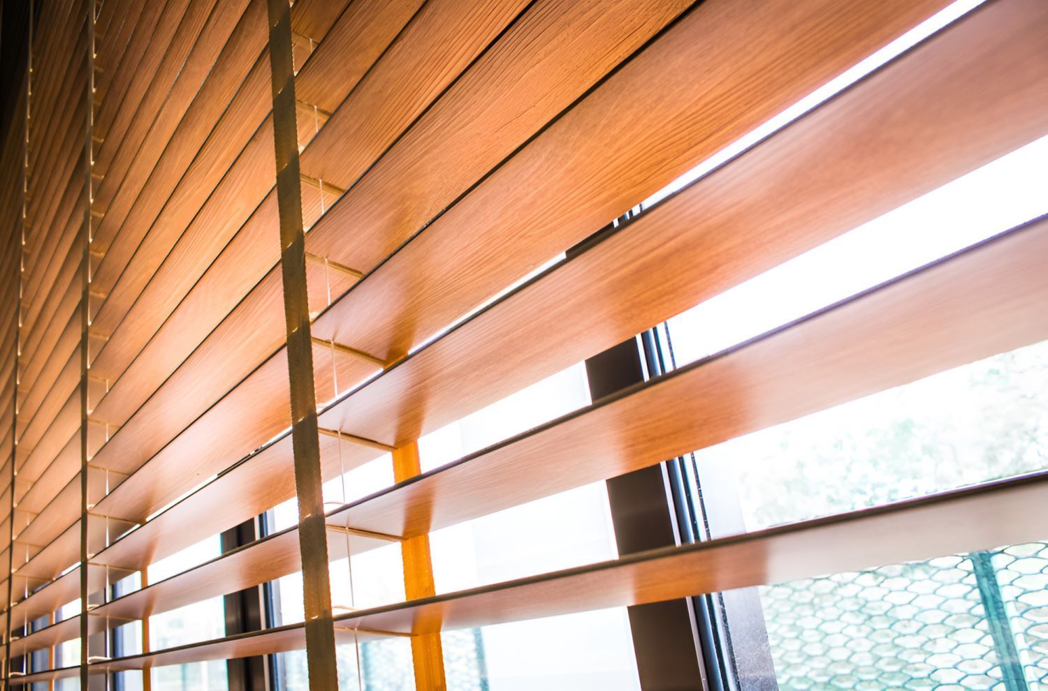 A Close Up of a Window With Wooden Blinds — Homestead Blinds in Wodonga, VIC