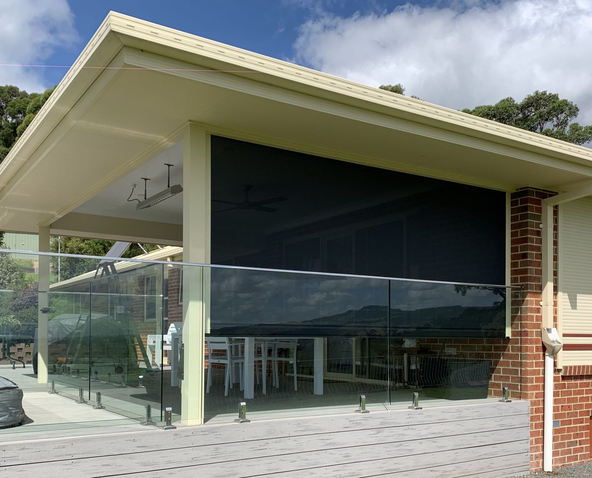 An outdoor blind on a house with brick walls — Homestead Blinds in Wodonga, VIC