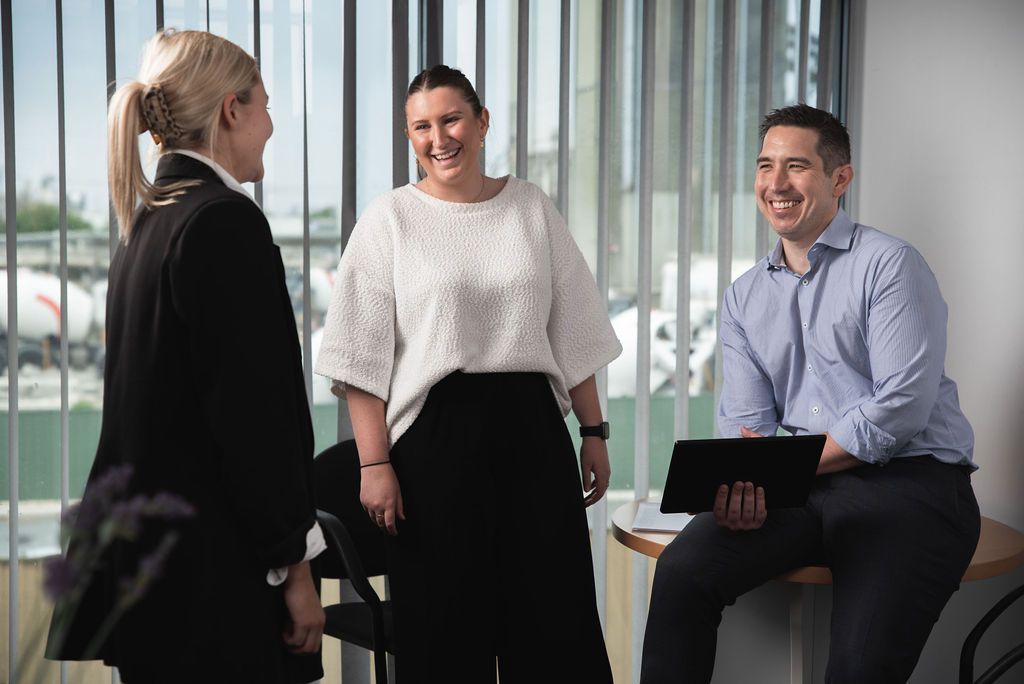 Photo of Matthew Holden, Managing Partner, talking with Georgia Lang, Supervisor and Georgina Davies, Intermediate.