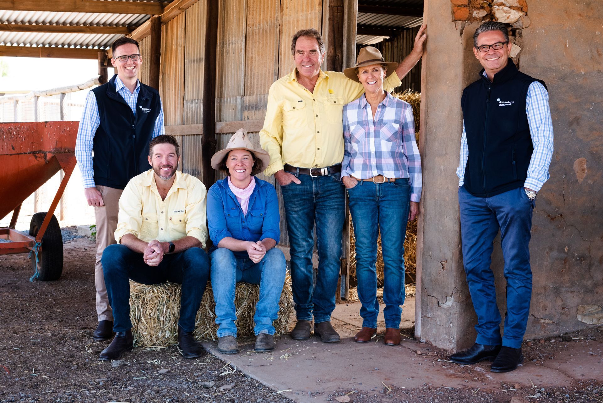 Schell Family farmers standing with Rick Albertini, Partner and Bradley Barnes Partner on their family farm.